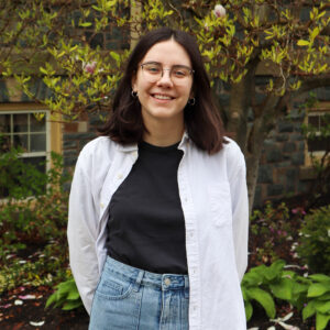 Sara MacCallum standing outside in the Quad under a magnolia