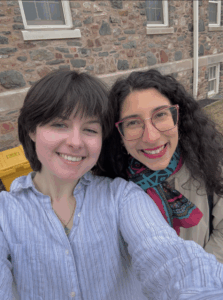 2 women stand for selfie outside King's residence