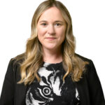 Stephanie McGrath smiling in front of white backdrop.