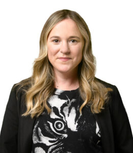 Stephanie McGrath smiling in front of white backdrop.