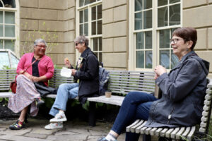 3 attendees take a break in Willwerth Garden