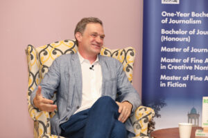 Patrick Radden Keefe smiles during his lecture in Alumni Hall.
