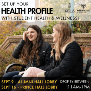 Two young people sitting on a bench in the fall wearing fall jackets. They have foliage and a stone wall behind them