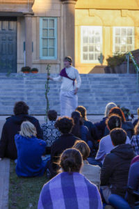 Actor delivering speech at Classics in the Quad with library in background and audience in foreground
