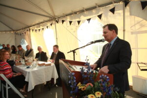 President Bill Lahey delivers remarks at dinner outside under tent.