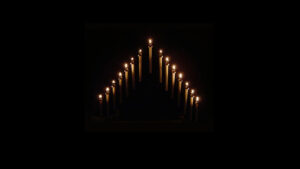Tenebrae candles lit and glowing on black background
