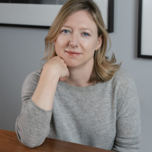 photo of Genevieve Scott, sitting at table, elbow on table, hand under chin
