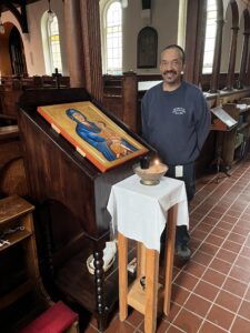 Carpenter Rodney Parsons next to the stand he build for the new chapel icon