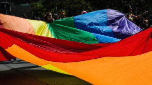 People holding up huge pride flag during pride parade