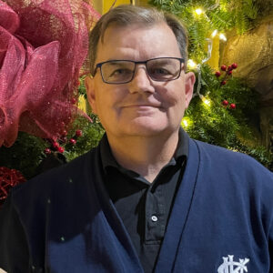 President Bill Lahey in front of holiday decorations wearing King's sweater