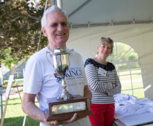 John Godfrey and Trish Bognard-Godfrey. John is holding the trophy of the Godfrey Run a special event at the 225th anniversary of King's.