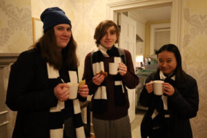 3 students at the Lodge enjoying hot chocolate after the Skating Party