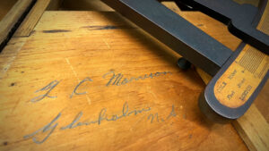 a British octant partial view with wooden background and pencilled signature of a person named Morrison from Nova Scotia.