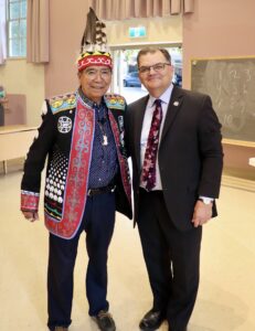 Chief Augustine and Bill Lahey stand next to each other in Alumni Hall