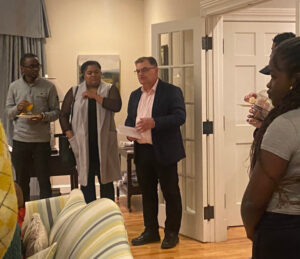 Bill Lahey delivers remarks near living room door of lodge to Black students and guests