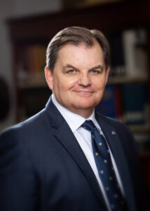 headshot of Bill Lahey wearing suit and tie and neutral background, maybe bookshelves.
