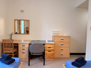 two desks against wall with dresser in temporary double room in Alex Hall.