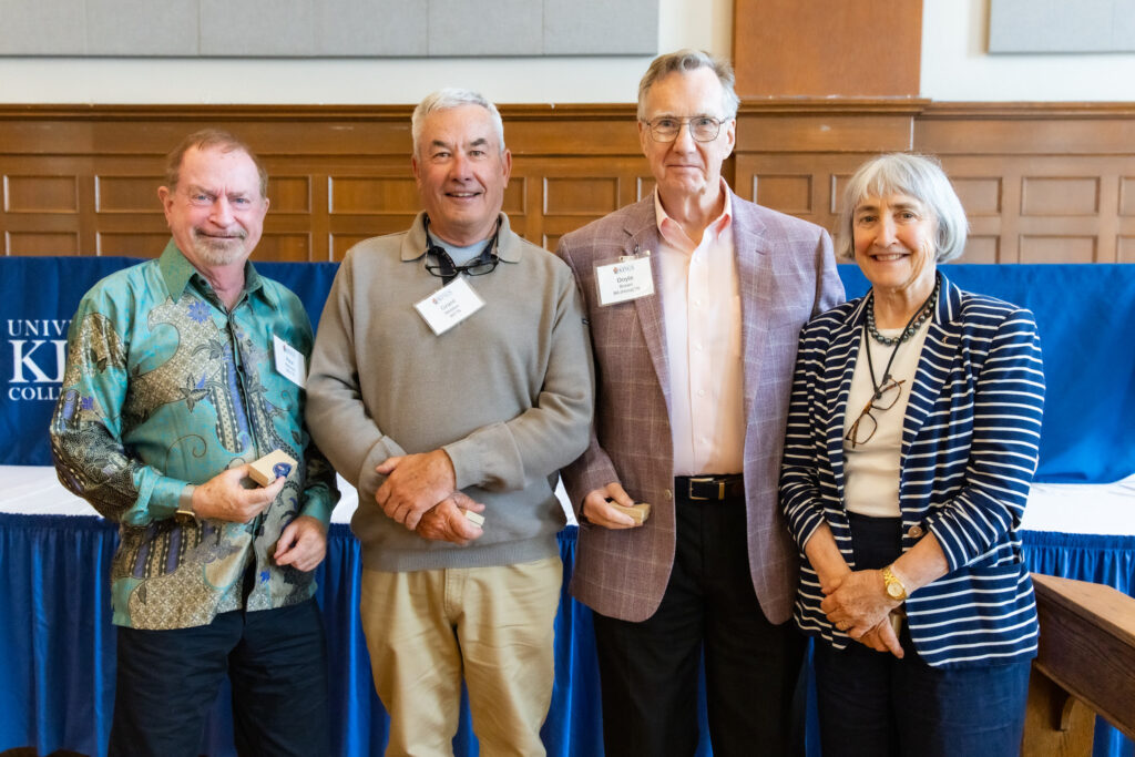 group shot of four alumni getting their 40th anniversary pins