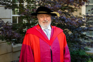 Dr. Kimber in his red doctoral robe and black cap after receiving his honorary doctorate at King's